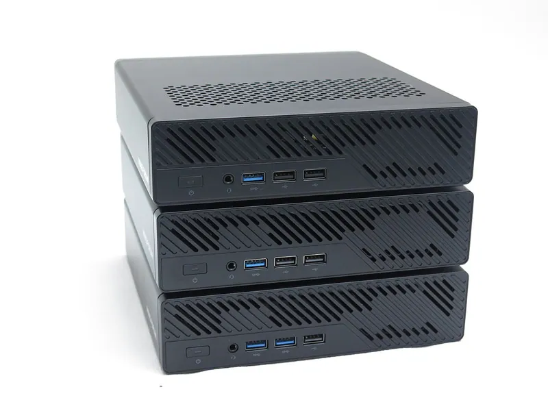 Three stacked Minisforum MS-R1 Mini PCs showing front I/O ports and vented front panel