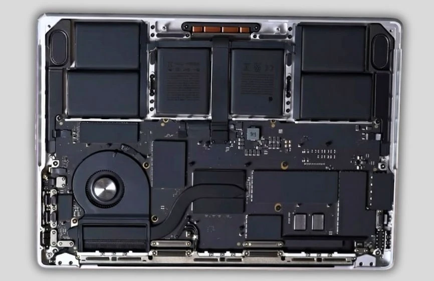 Apple MacBook Pro M5 Review: Full Spes, Real Performance, Battery & Testing 6 Internal view of Apple MacBook Pro M5 showing battery modules, cooling system, and logic board layout