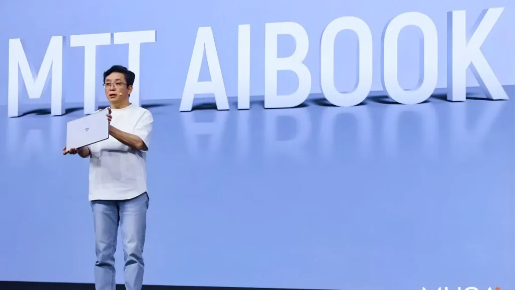 Moore Threads showcases the MTT AIbook laptop powered by the Yangtze AI SoC during a product announcement.