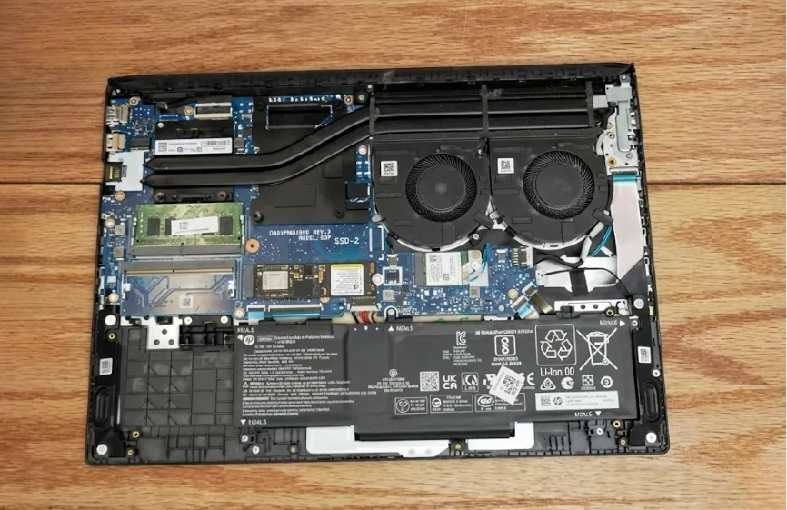 Best Laptop for AutoCAD and Revit in 2026: Our Top Picks 54 Internal view of HP Victus 15 showing dual cooling fans, heat pipes, battery, memory slots, and motherboard layout