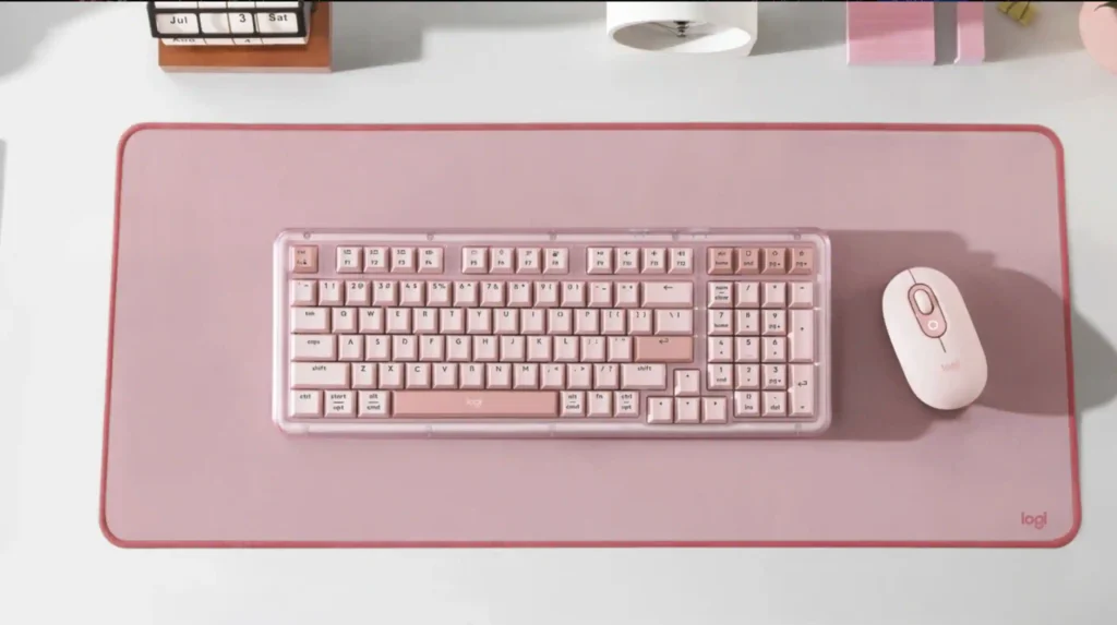Logitech Alto Keys Amber K98 Plus Keyboard Adds Tri-Mode, 1K Wired Polling 1 Logitech Alto Keys Amber K98 Plus keyboard displayed in pink color with matching mouse and desk mat