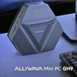 ALLIWAVA GH9 Mini PC placed on a desk beside a keyboard and monitor, showing its compact geometric design