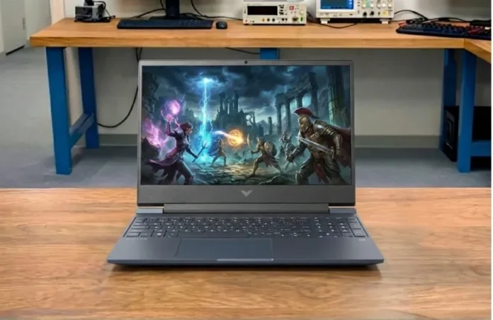 HP Victus 15 gaming laptop placed on our pcvenus testing lab desk with a game running on the display in a professional testing lab