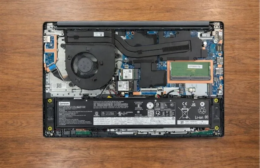 Internal view of Lenovo LOQ 15 Essential showing cooling fan, heat pipes, battery, memory slot, and motherboard layout