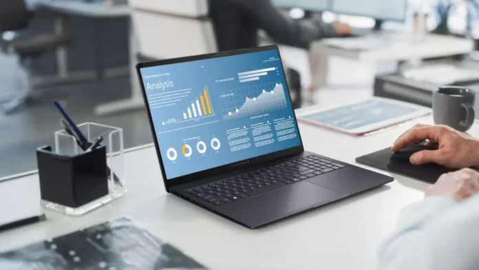 ASUS ExpertBook B5 G2 business laptop displaying analytics dashboard in office environment
