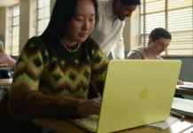 Apple MacBook Neo Launches With A18 Pro Chip, Starts at $599 Student using Apple MacBook Neo laptop in a classroom environment