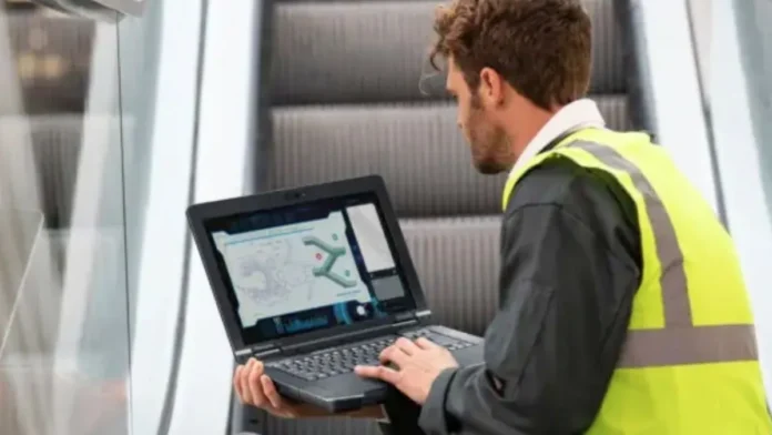 Technician using Panasonic TOUGHBOOK 56 rugged laptop while standing in an industrial environment