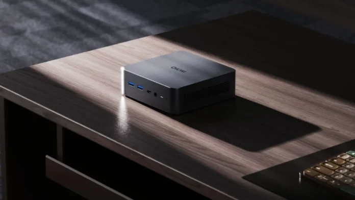 Chuwi AuBox X mini PC placed on desk showing compact design