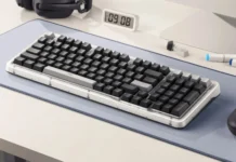 Logitech Alto Keys Amber K98 Plus Keyboard Adds Tri-Mode, 1K Wired Polling Logitech Alto Keys Amber K98 Plus keyboard shown at angle with black keycaps on desk setup