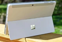 Microsoft Raises Surface PC Prices by Up to $500 After Hardware Cost Increase Microsoft Surface PC tablet-laptop hybrid shown from rear with built-in kickstand open outdoors