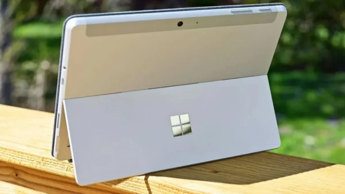 Microsoft Surface PC tablet-laptop hybrid shown from rear with built-in kickstand open outdoors